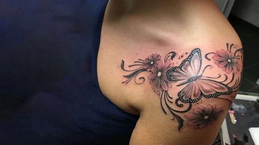 Beautiful butterfly tattoo with flowers on side