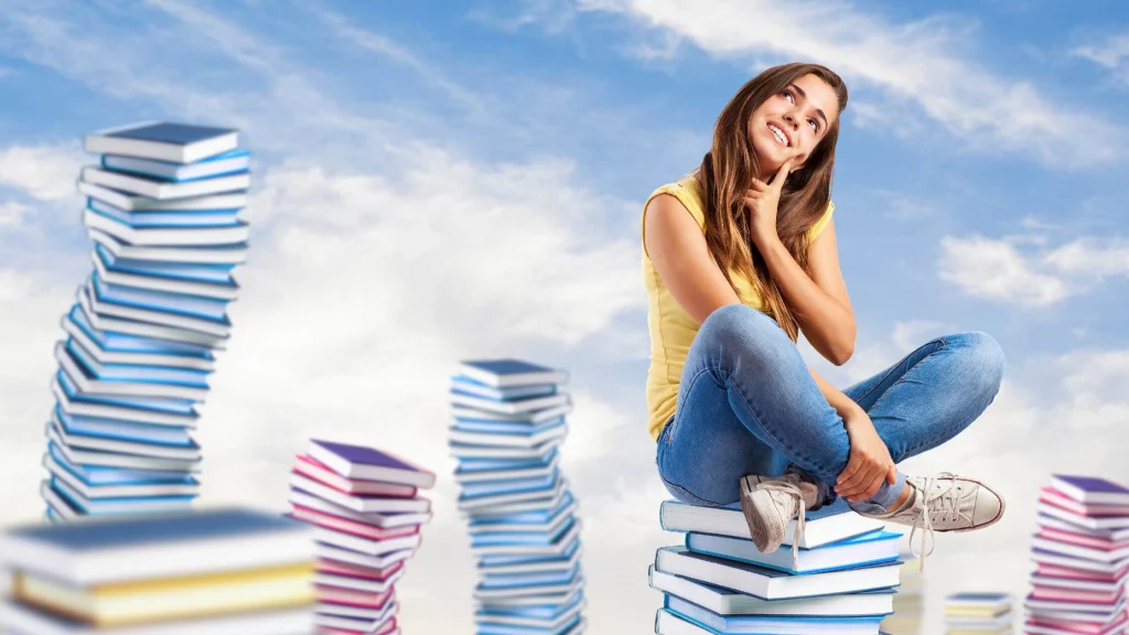 A girl sitting on books on a cloud
