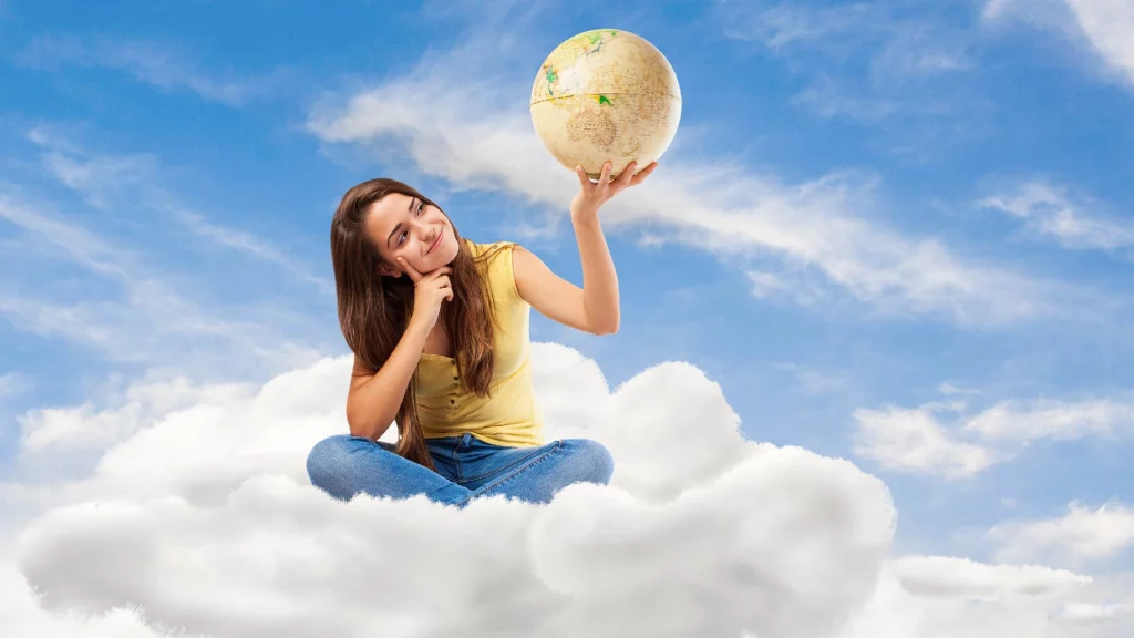 a girl sitting on a cloud with a globe in her hands