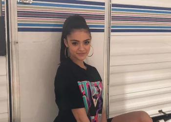 Luna Blaise at sitting outside vanity van wearing a black top