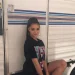 Luna Blaise at sitting outside vanity van wearing a black top