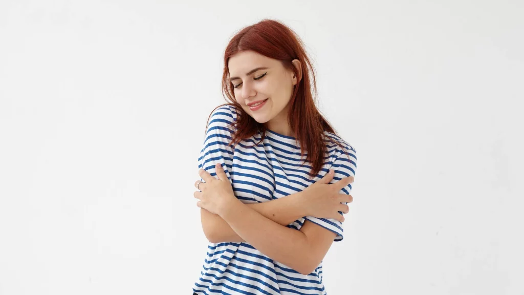 a girl hugging herself