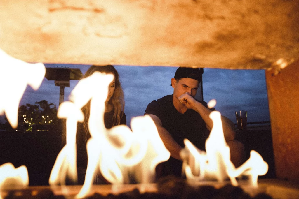 couple sitting Infront of fire