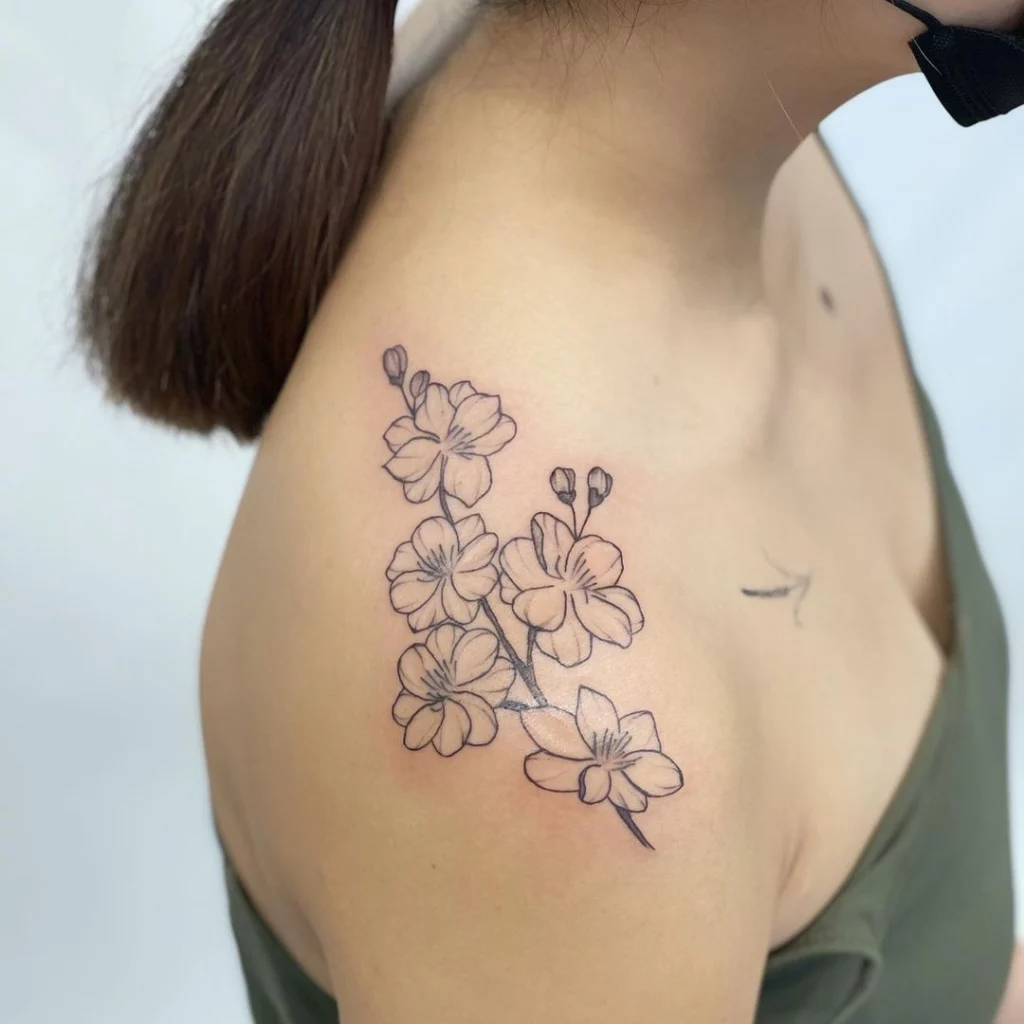 shoulder tattoo of little daffodils flowers 