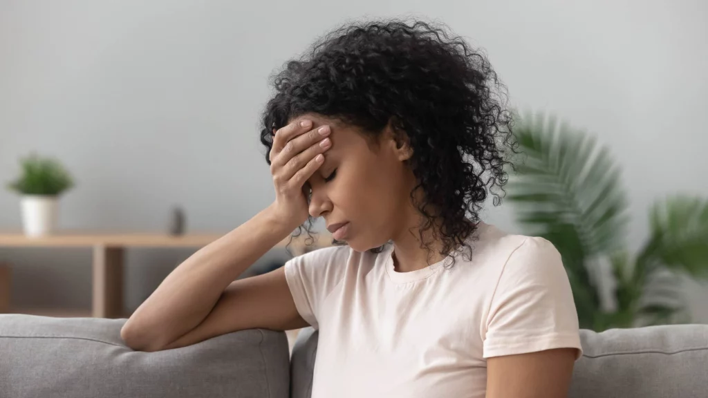 Upset girl sitting on sofa