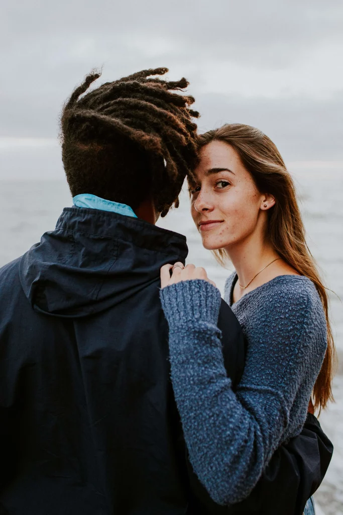 Girl keeping hand on a guy's shoulder