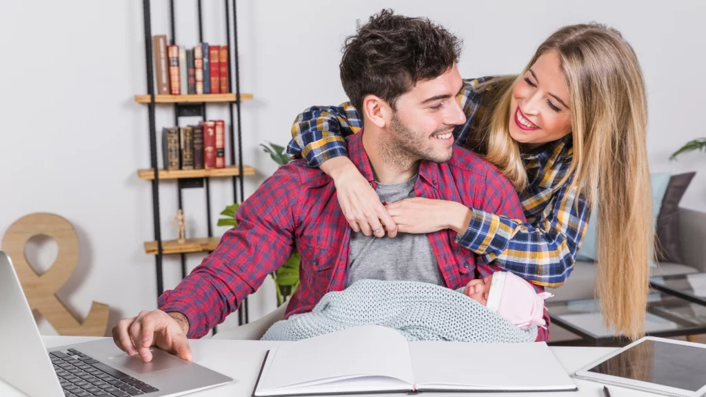 Girl hugging her boyfriend while studying