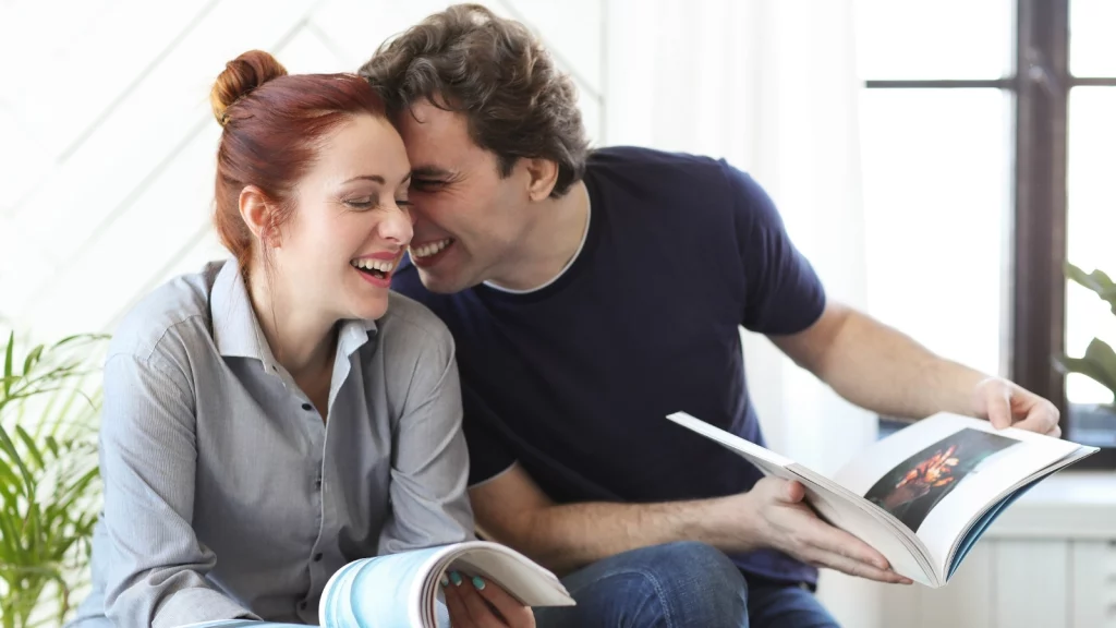 couple laughing while reading books