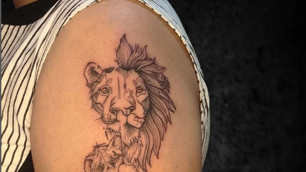 A lion face tattooed on Shoulder