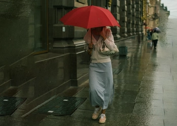 a women holding red umbrella