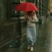 a women holding red umbrella