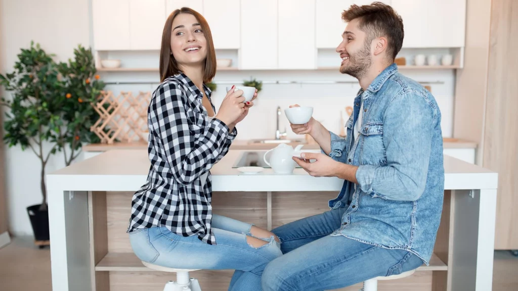 A girl ad a boy drinking tea together