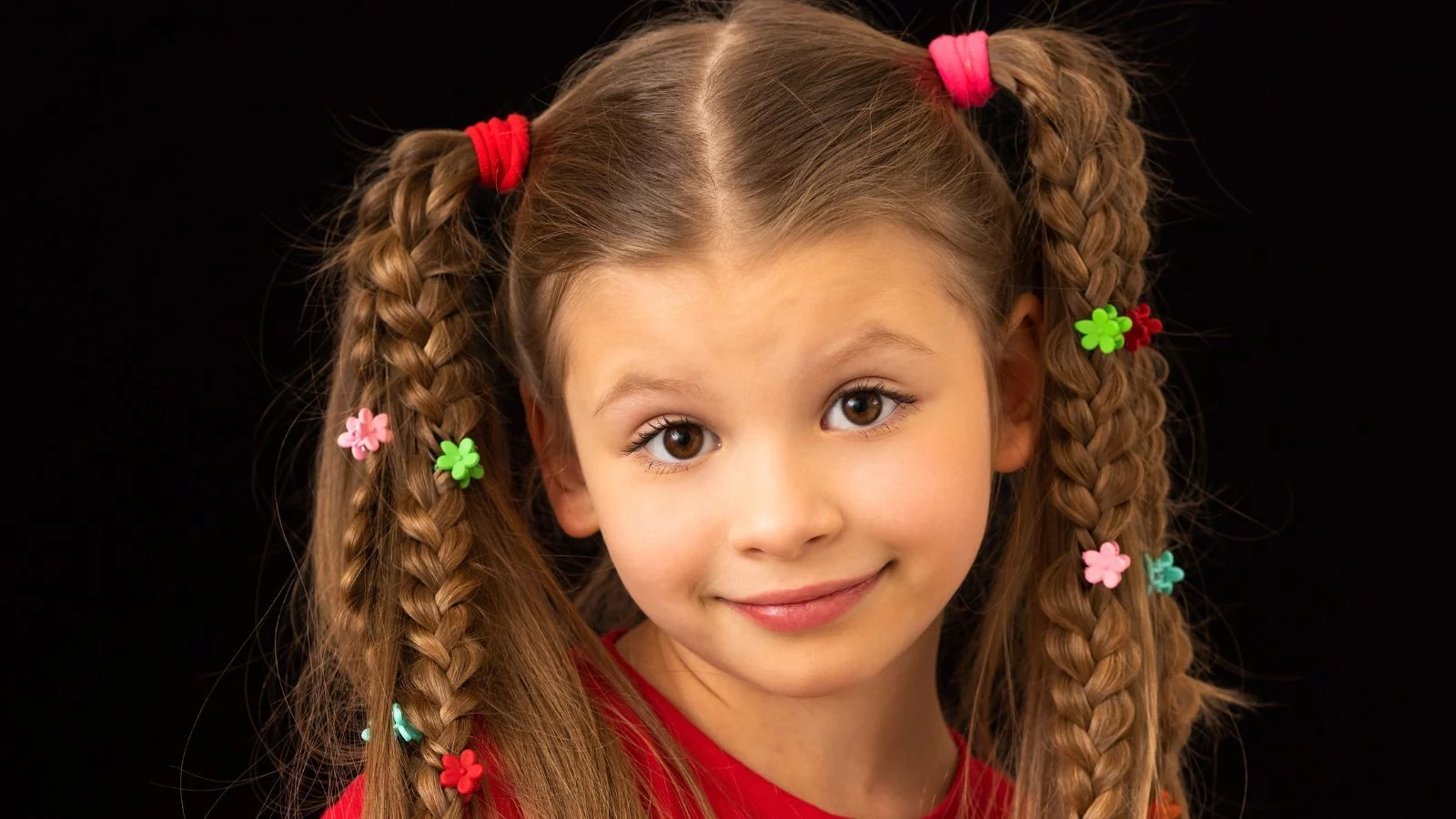 A girl smiling with waterfall braids on both sides. 