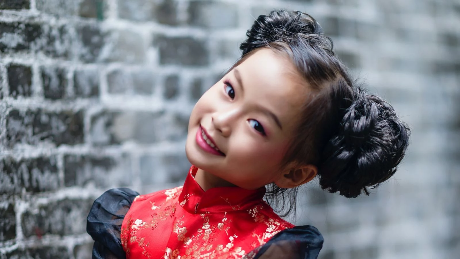 An Asian girl with braided double-side buns hairstyle. 
