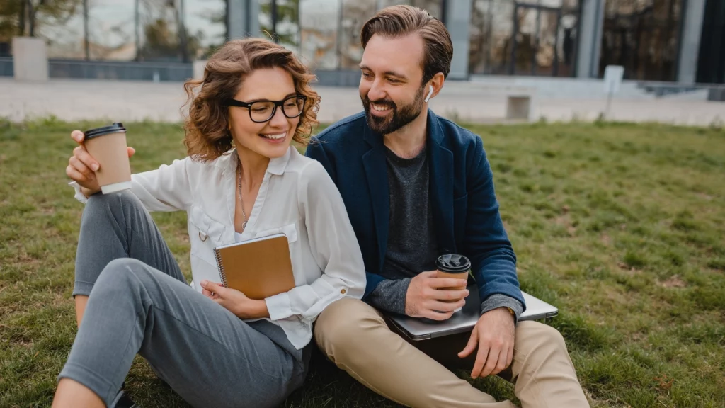 a couple sitting in park laughing