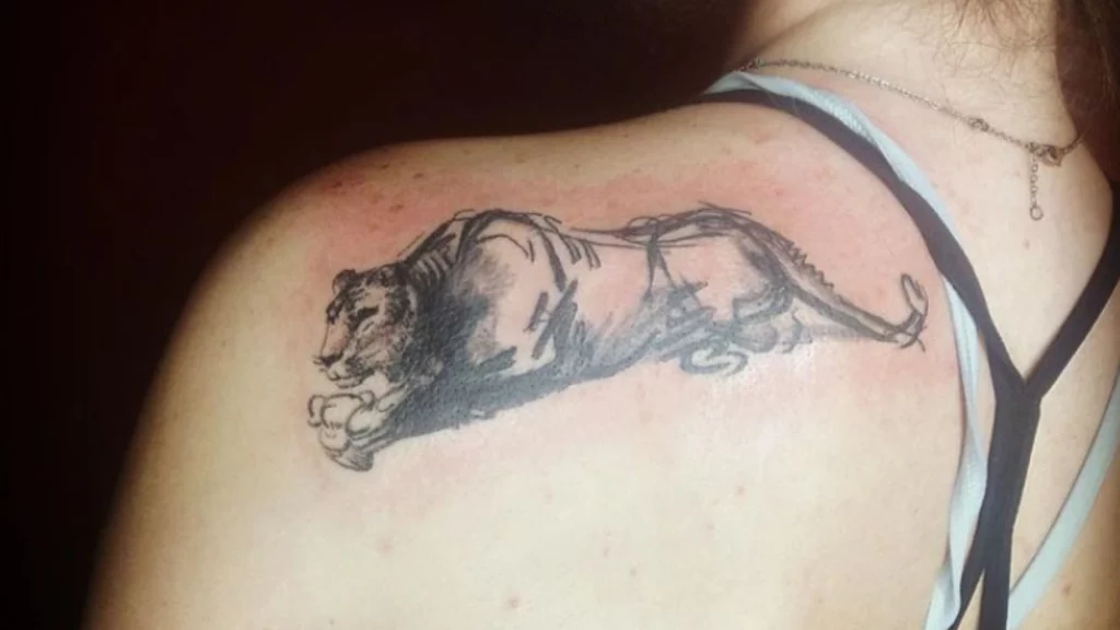 A leopard tattoo on back shoulder.