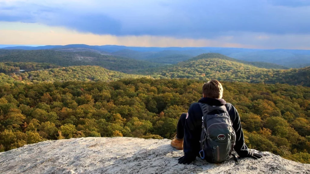 Man sitting on the edge of the mountain of the Black Rock Forest trail 