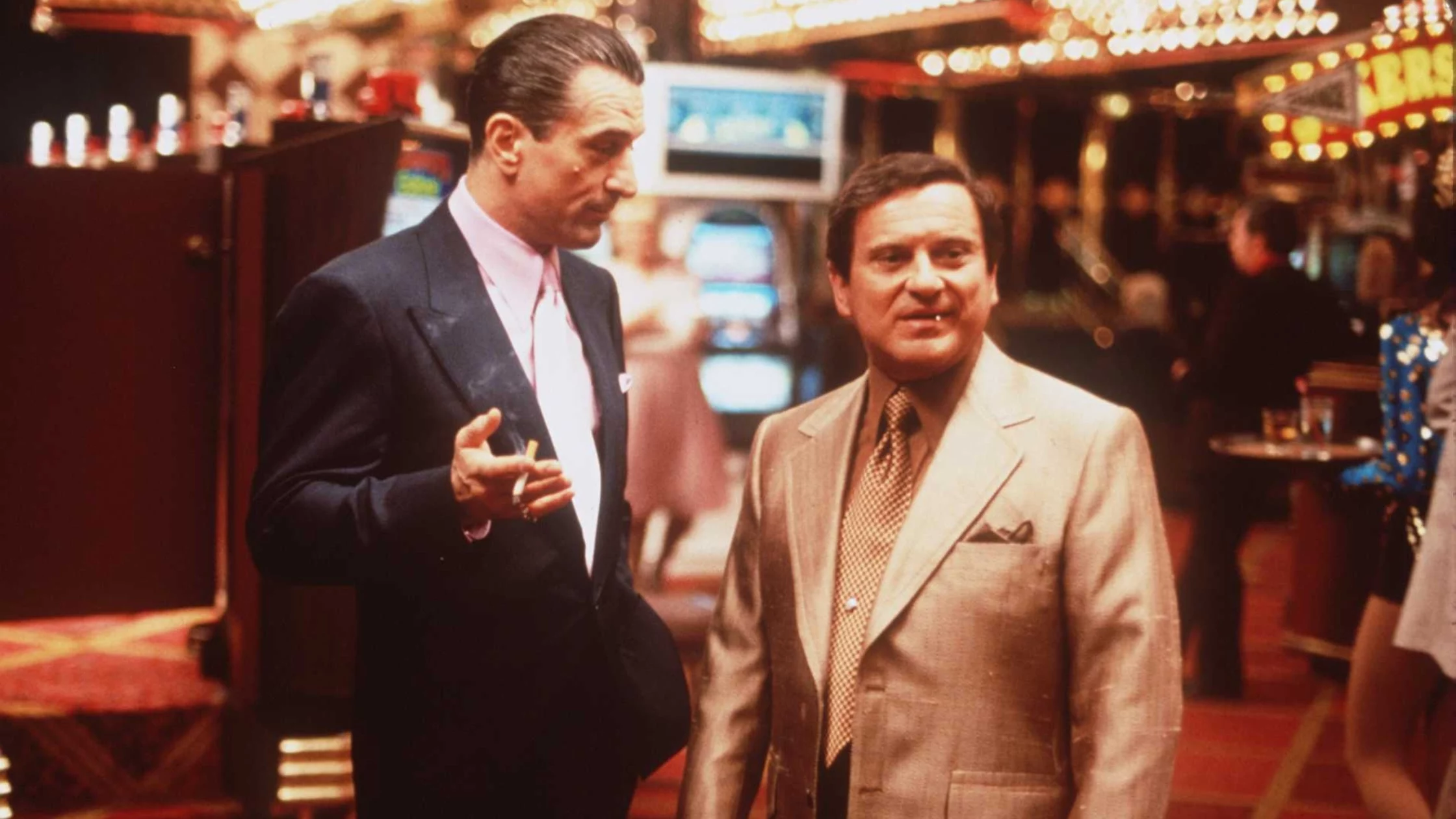 Two men smoking cigarettes in a Casino. 
