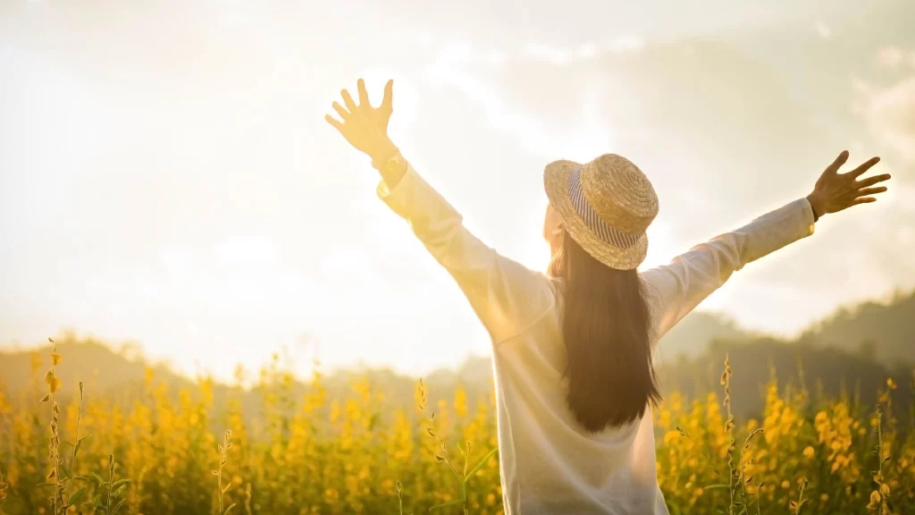 girl facing the sun in daytime