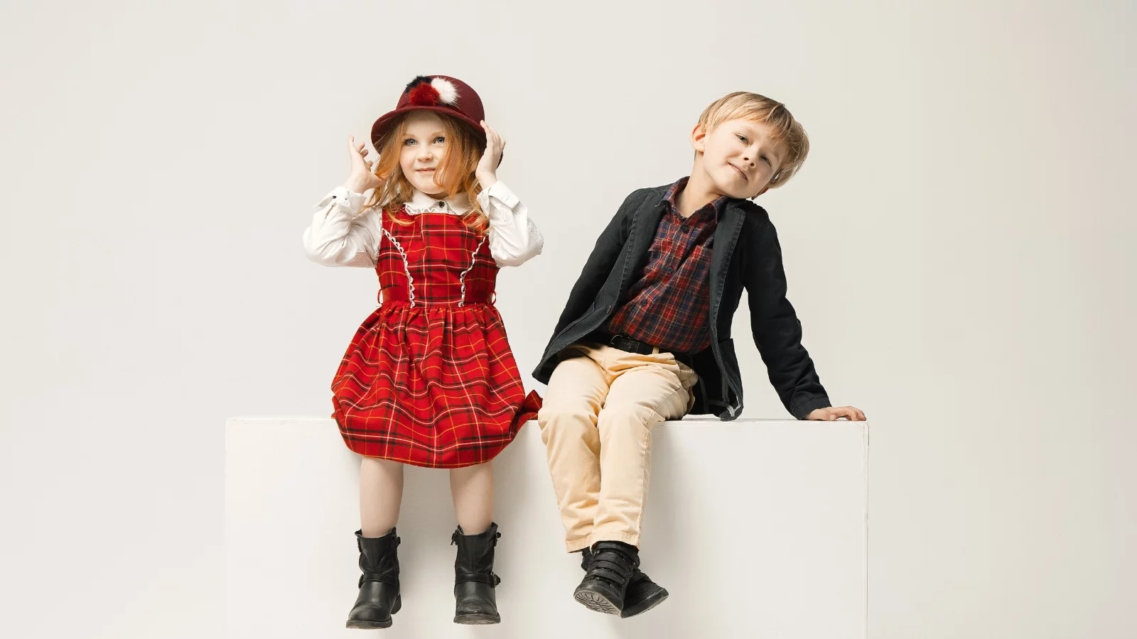 Girl and a boy wearing grown up's dresses. 