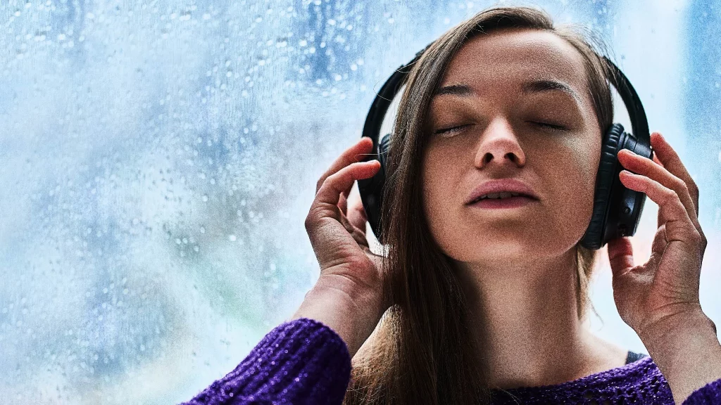 a girl listening music on headphones.