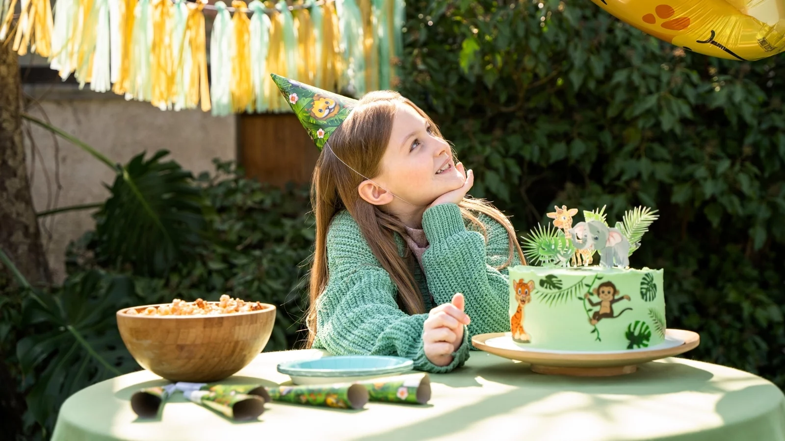 Picture of a girl in the garden with a cake. 