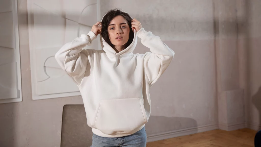 girl posing in white hoodie