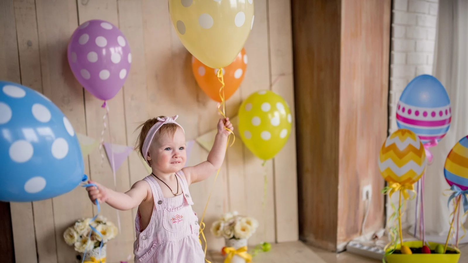 A child playing with balloons. 