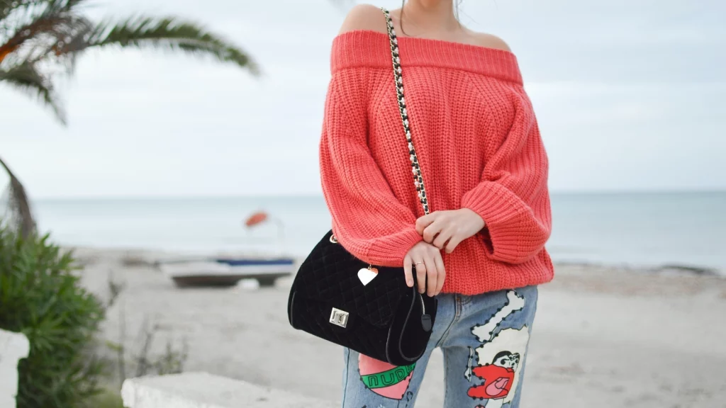 girl wearing red off shoulder sweater
