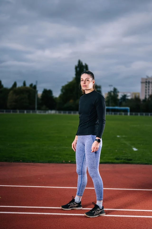 A girl in full sleeves T-shirt and joggers. 