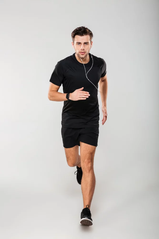 Man running in a shirt and shorts. 