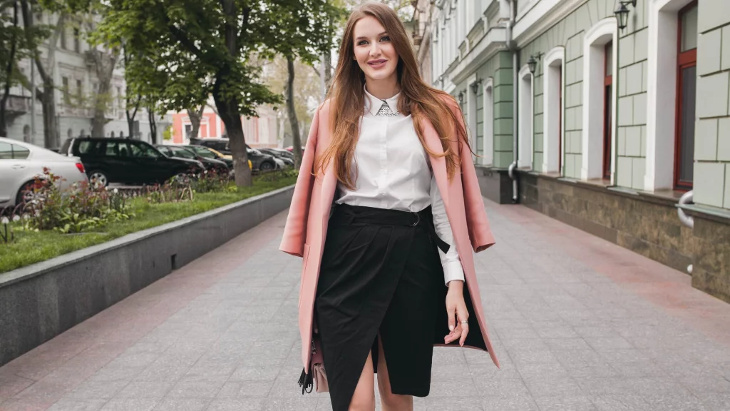girl wearing black skirt and pink overcoat