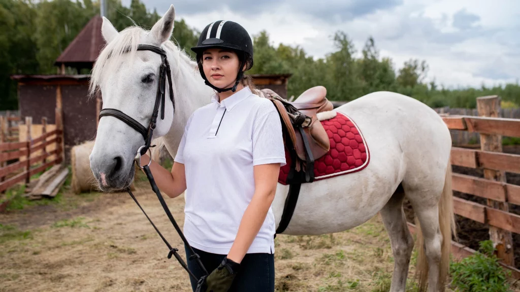 Black and white outfit wearing girl standing with horse