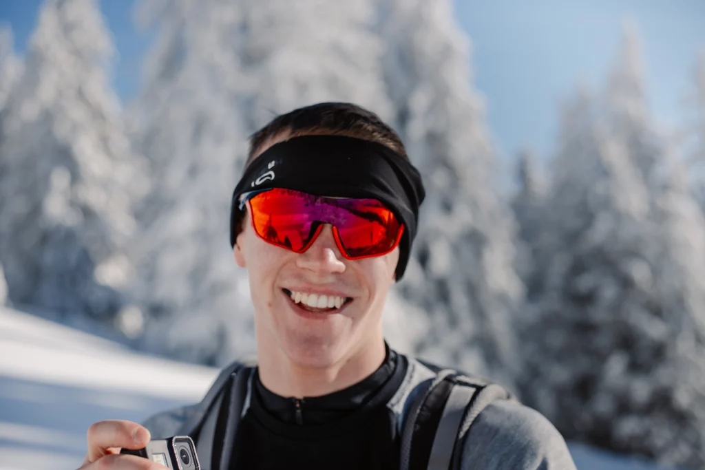 a man smiling in snow