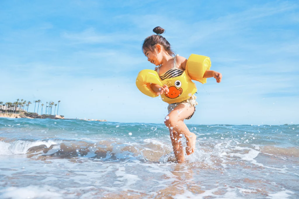 girl playing at the beach