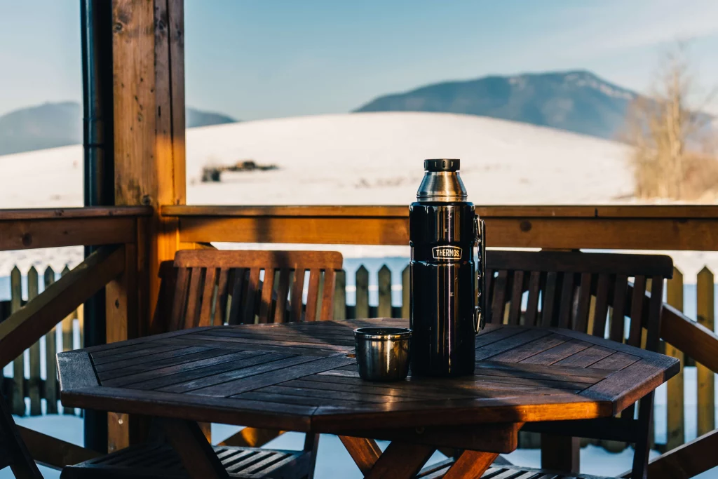 black thermos on wooden table