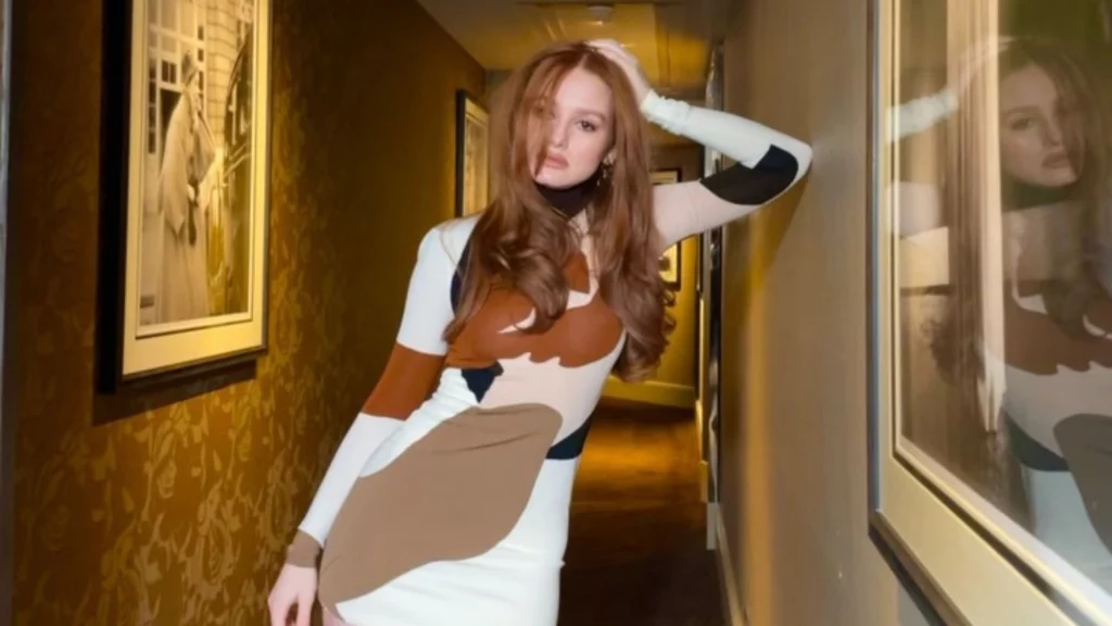 Madelaine Petsch posing in white dress