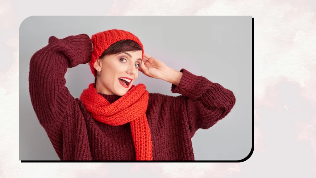 A girl wearing a Red colored Chunky Knit Sweater and Scarf.