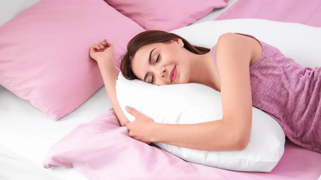 woman sleeping with pink pillows