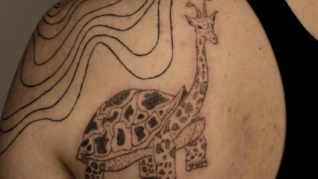 giraffe tattoo on back shoulder