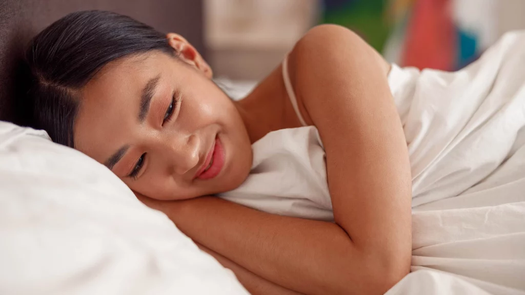 girl smiling while lying on the bed