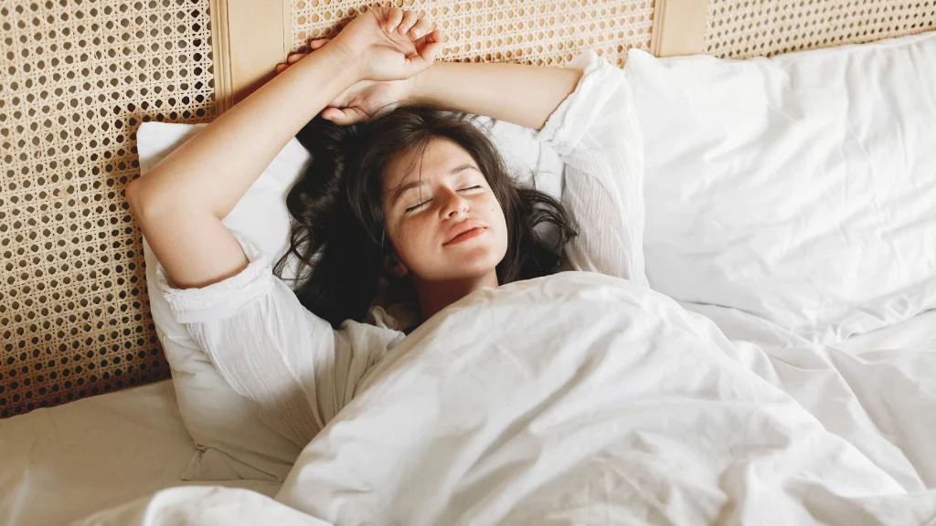 Woman sleeping with hands over her head