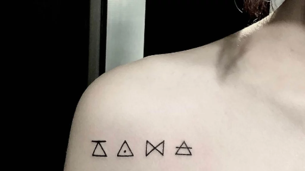symbols tattoo near shoulder