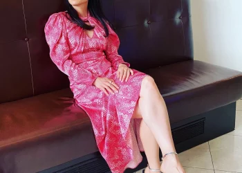 Lucy Liu sitting on a sofa