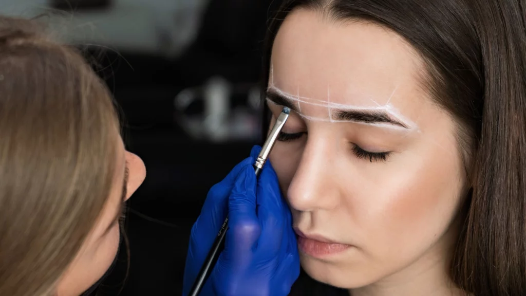 a girl getting her eyebrows fix